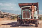 Nude girl on the abandoned truck in Krk Island Croatia